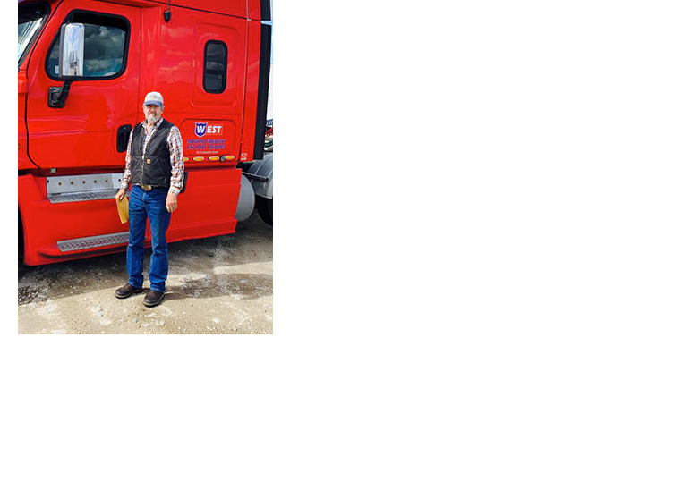 man-standing-in-front-of-red-truck